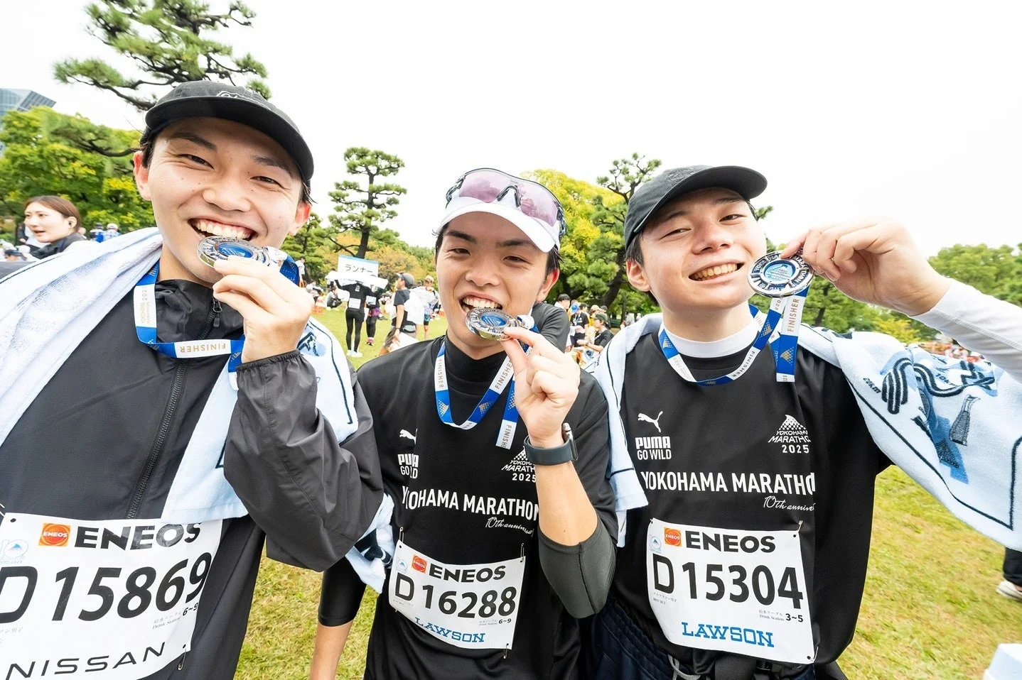 完走メダルを掲げるランナーたち